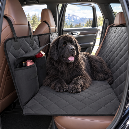 Newfoundland lying on the hard-bottom back seat extender in a car